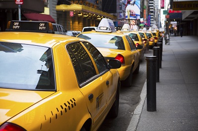 image of yellow cabs parked curbside