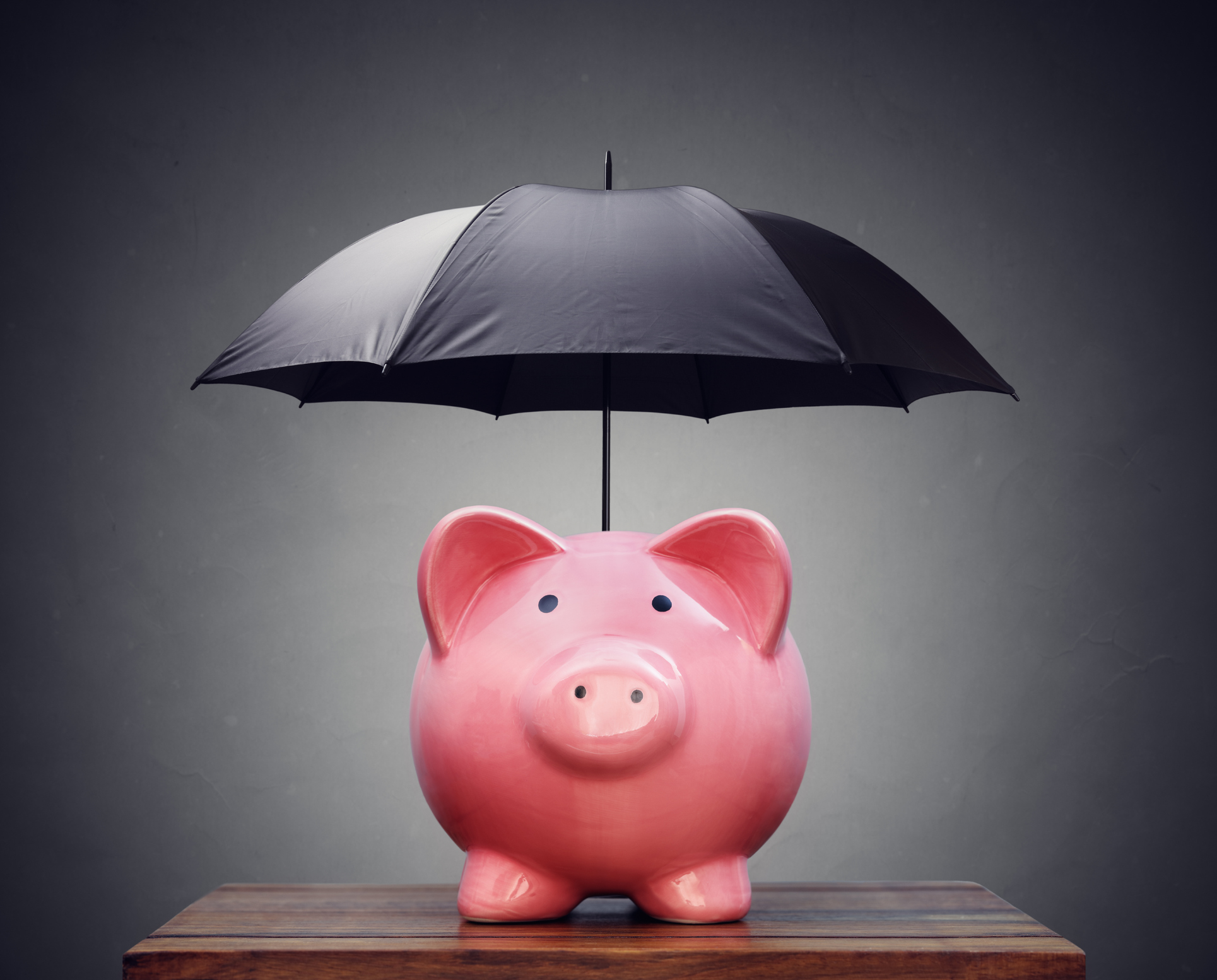 image of piggy bank with umbrella above it
