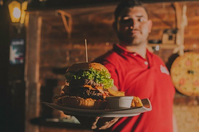 image of man serving burger in a restaurant