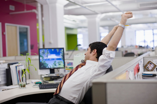 image of man stretching at desk