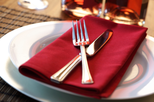 fork and spoon on a red napkin