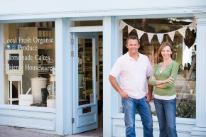 family in front of business