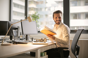 a person sitting at a table using a laptop