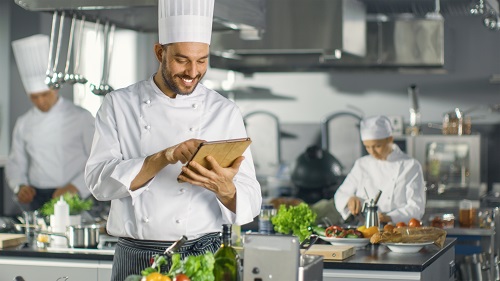 a chef looking at food list at restaurant
