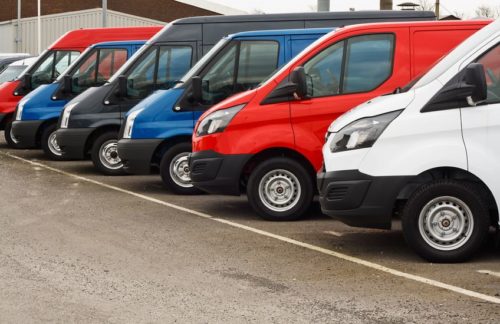 row of cars parked in a parking lot