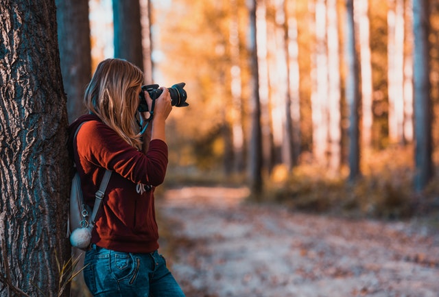 image of photographer in fall foliage